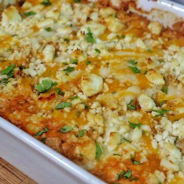 Creamy street corn chicken casserole baked with melted cheese, corn, shredded chicken, and garnished with cilantro.