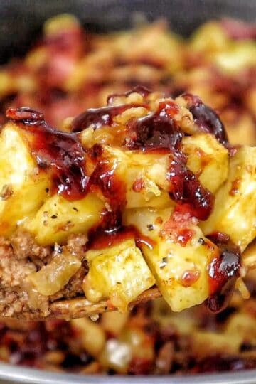 BBQ Cheeseburger Potato Skillet loaded with crispy potatoes, seasoned ground beef, melted Colby Jack cheese, bacon crumbles, crispy fried onions, and drizzled BBQ sauce