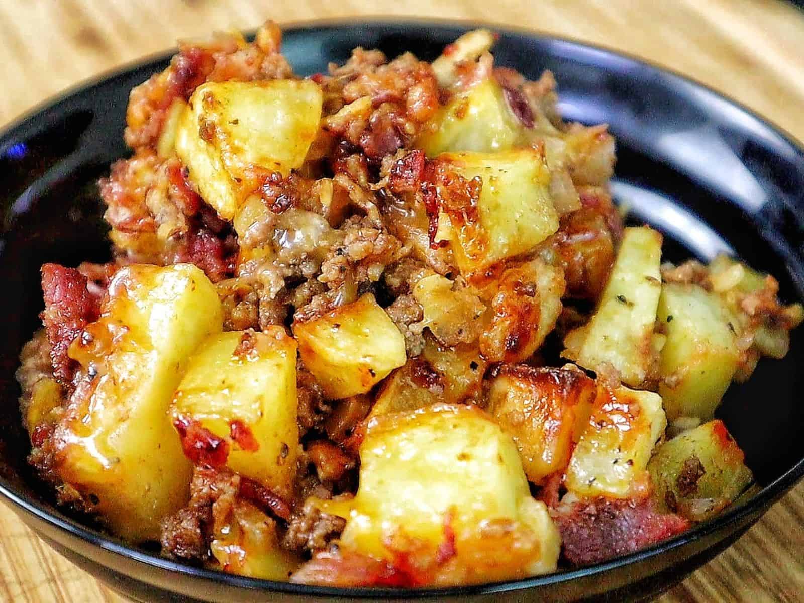 BBQ Cheeseburger Potato Skillet loaded with crispy potatoes, seasoned ground beef, melted Colby Jack cheese, bacon crumbles, crispy fried onions, and drizzled BBQ sauce
