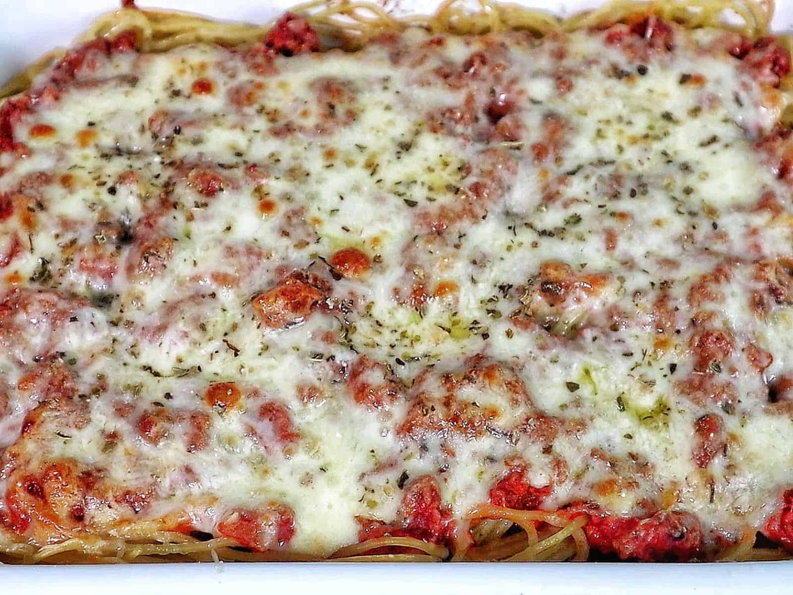 Cheesy baked Chicago Style Spaghetti layered with meat sauce, spaghetti noodles, melted mozzarella, and parmesan cheese.