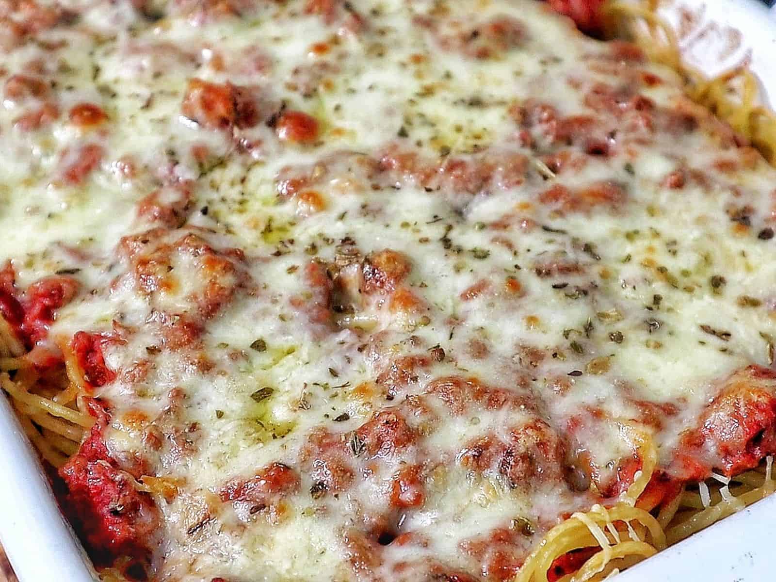 Cheesy baked Chicago Style Spaghetti layered with meat sauce, spaghetti noodles, melted mozzarella, and parmesan cheese.