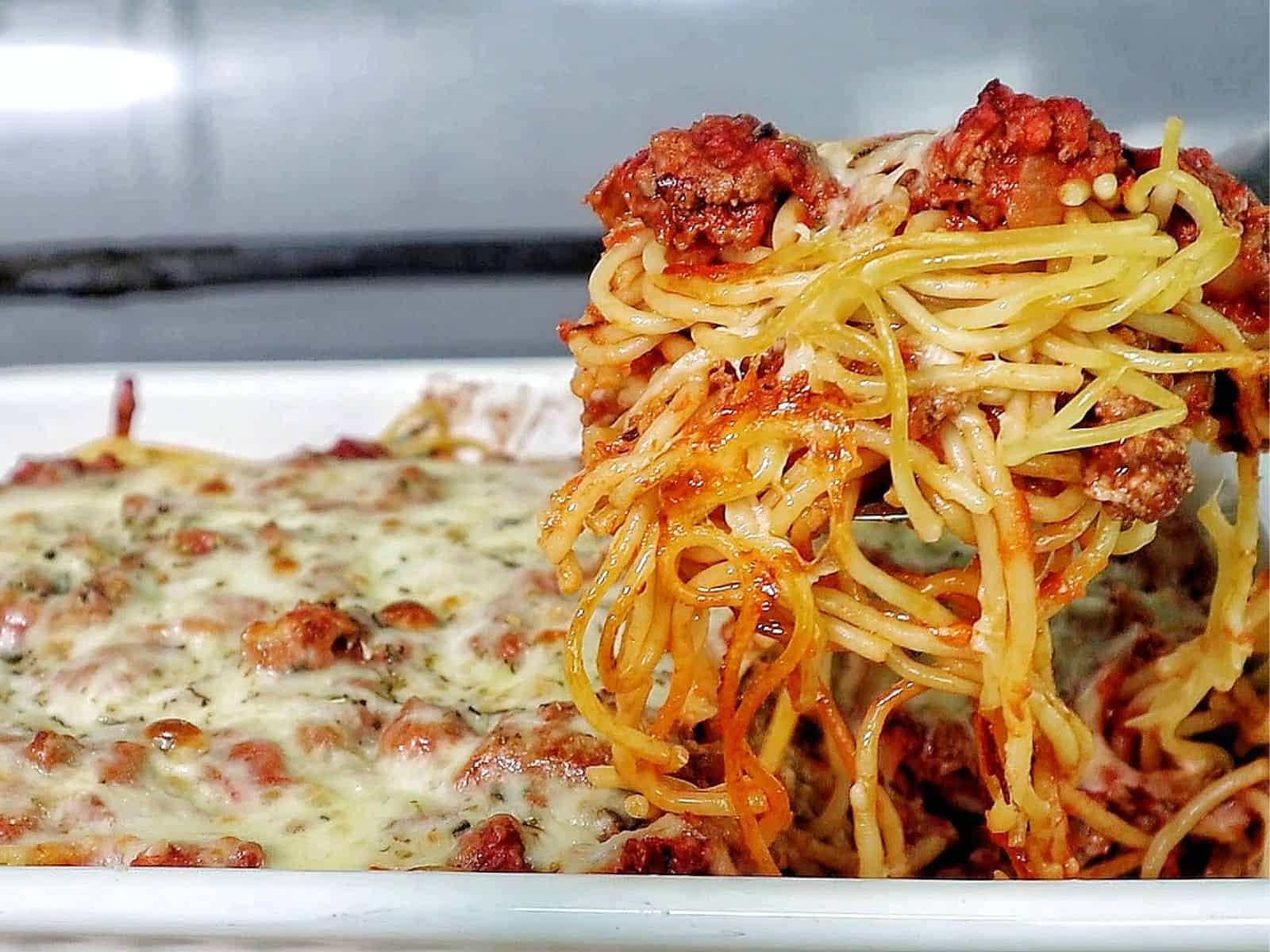 Cheesy baked Chicago Style Spaghetti layered with meat sauce, spaghetti noodles, melted mozzarella, and parmesan cheese.
