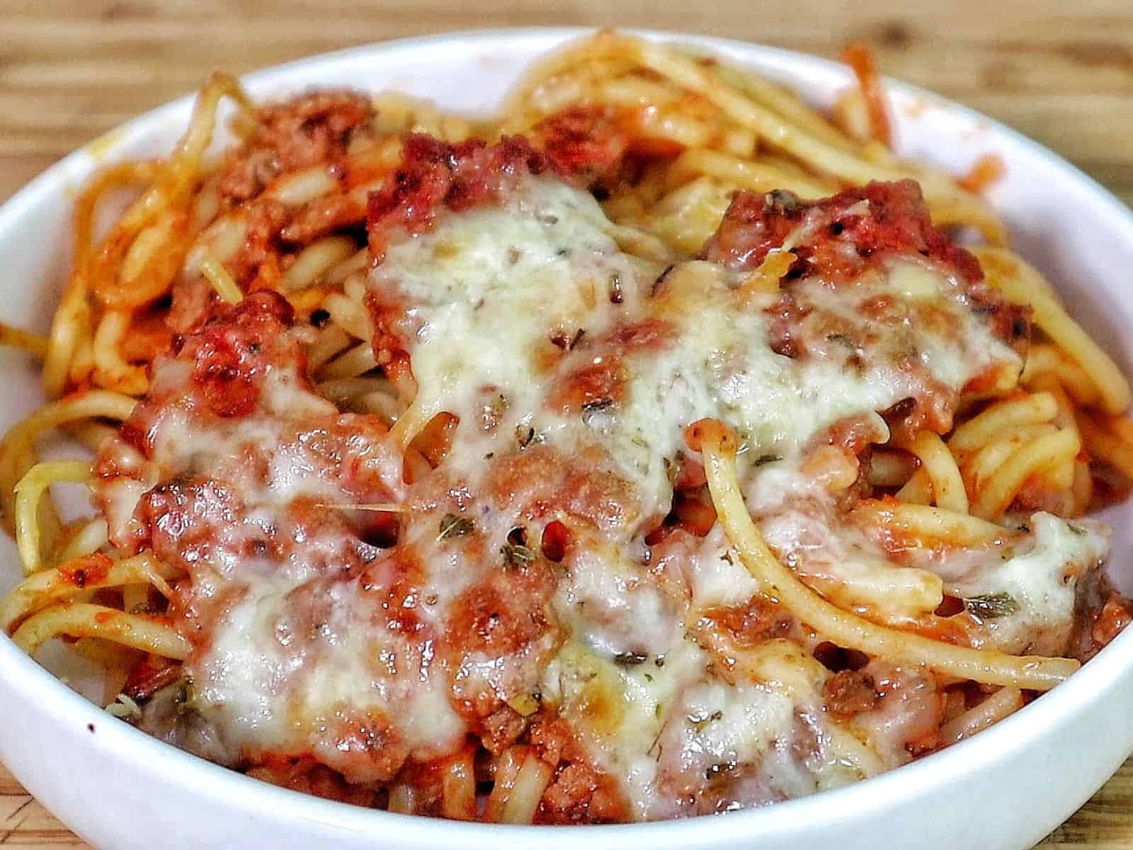 Cheesy baked Chicago Style Spaghetti layered with meat sauce, spaghetti noodles, melted mozzarella, and parmesan cheese.