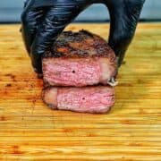 Perfectly grilled sirloin steak sliced medium-rare with a juicy pink center.