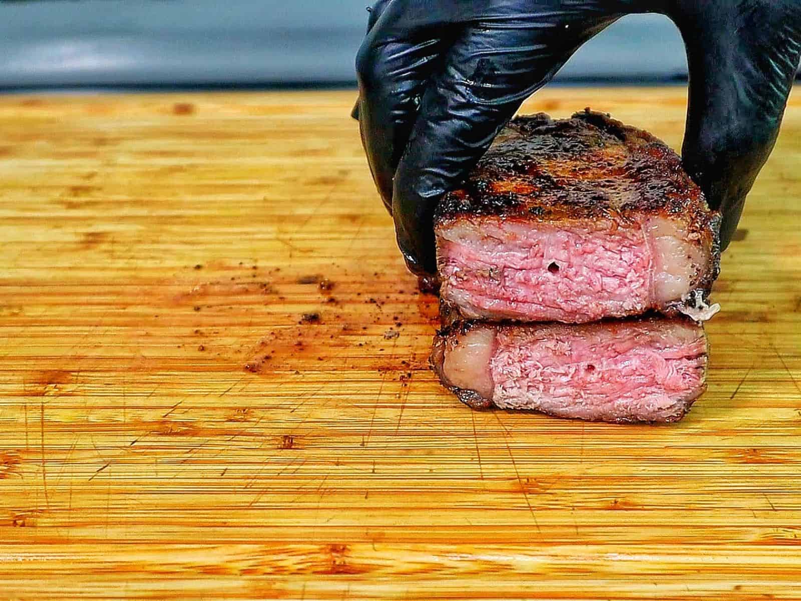Perfectly grilled sirloin steak sliced medium-rare with a juicy pink center.