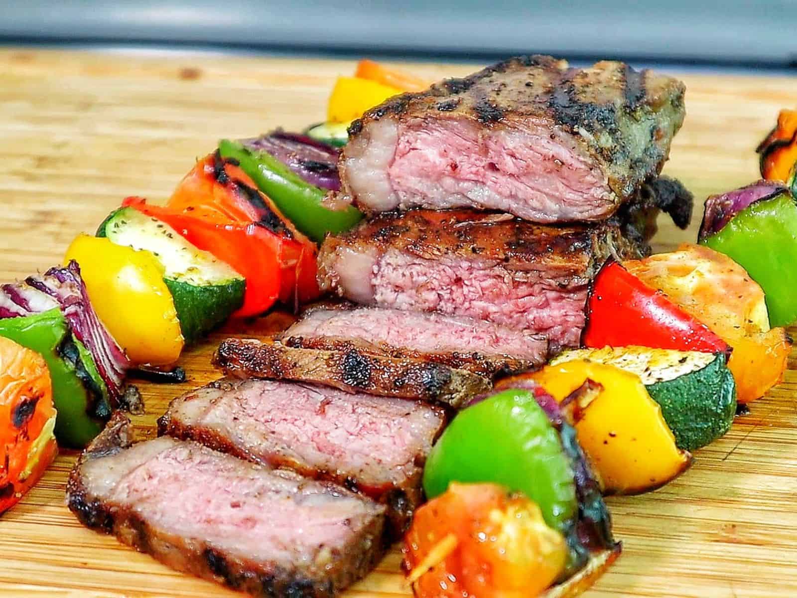 Perfectly grilled sirloin steak sliced medium-rare with a juicy pink center.
