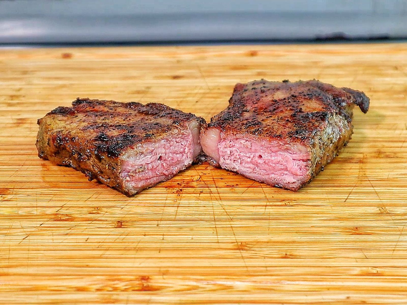 Perfectly grilled sirloin steak sliced medium-rare with a juicy pink center.
