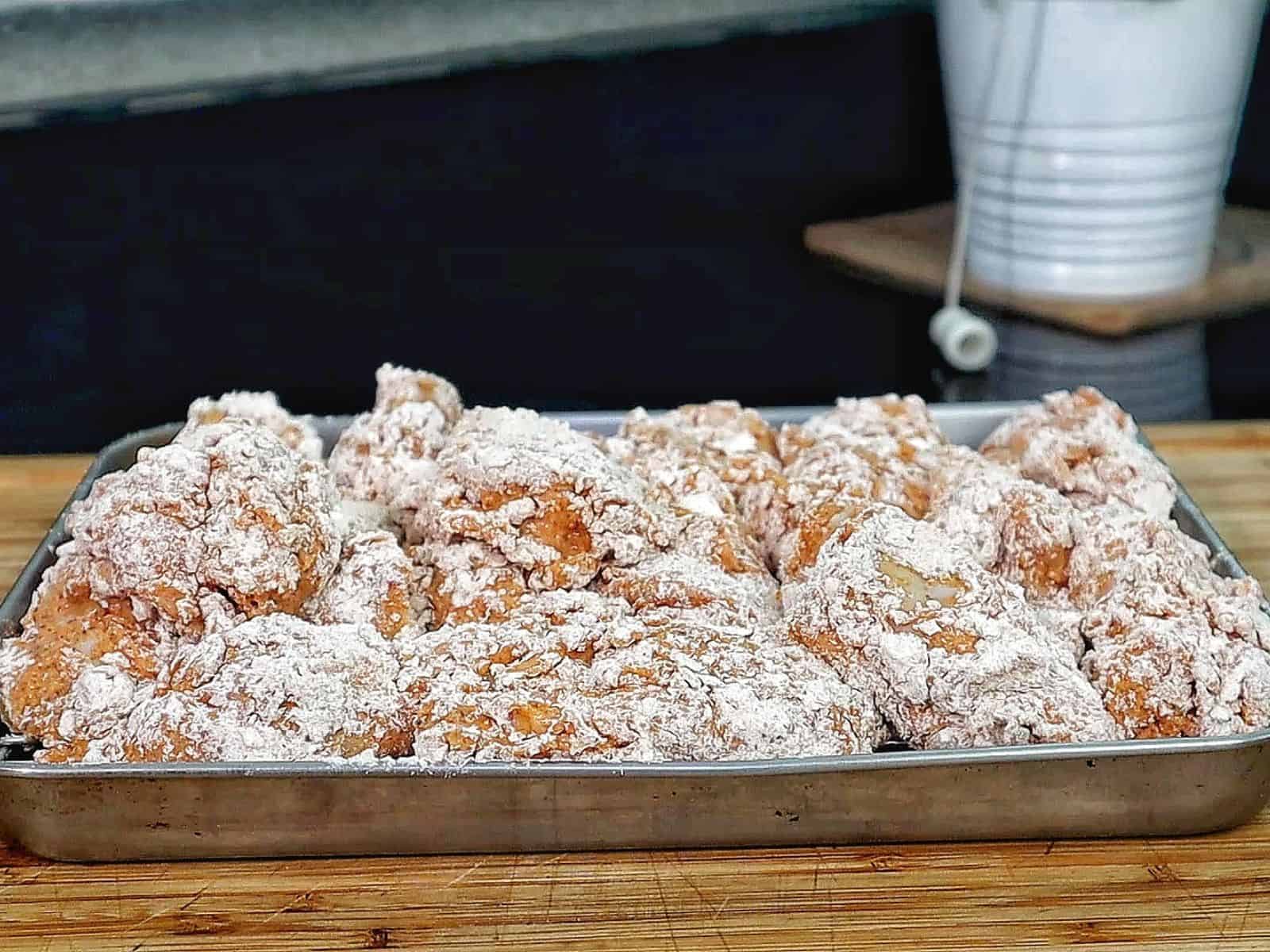 Crispy golden fried chicken wings coated in seasoned flour, with a crunchy textured crust.