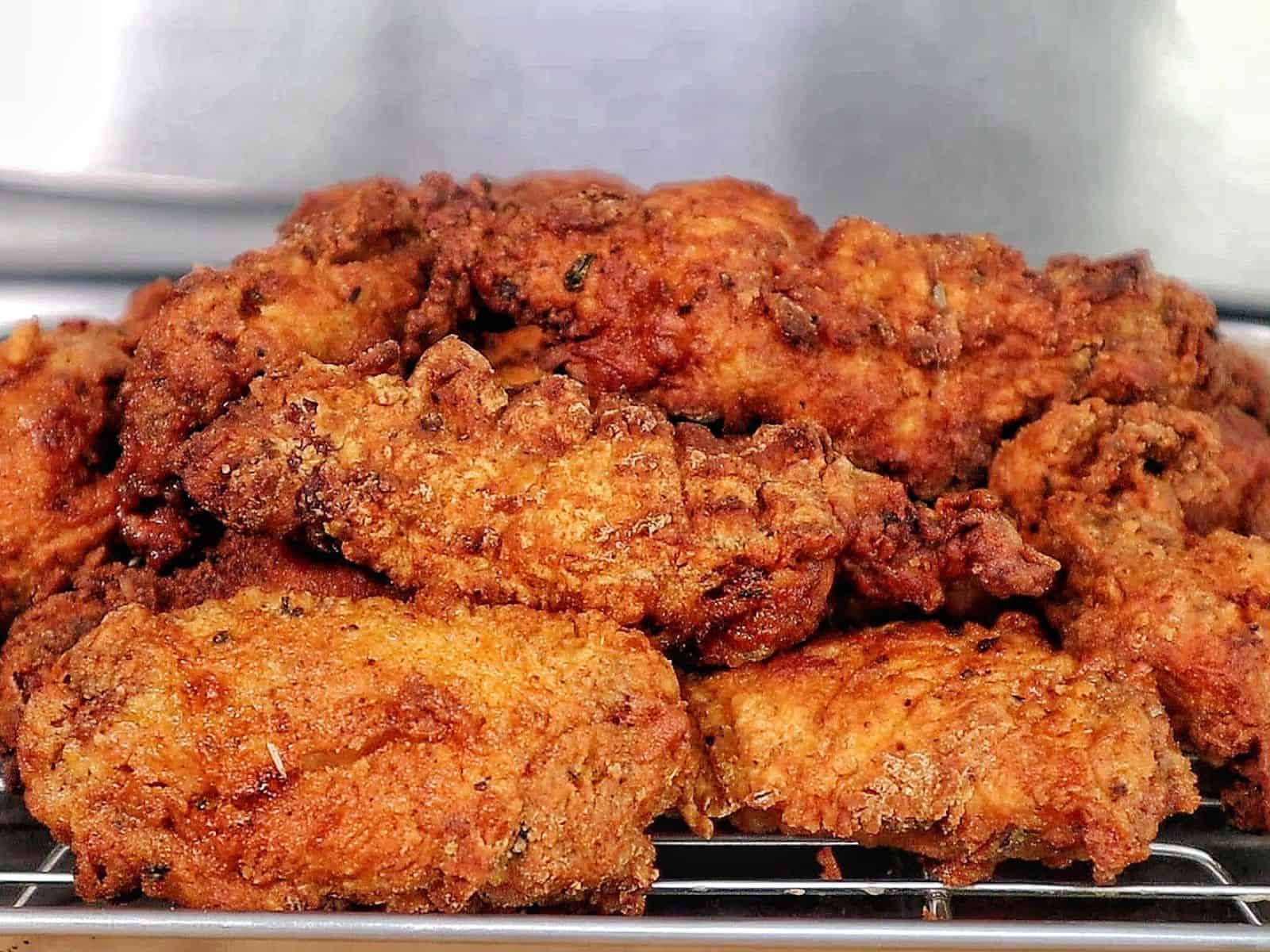 Crispy golden fried chicken wings coated in seasoned flour, with a crunchy textured crust.