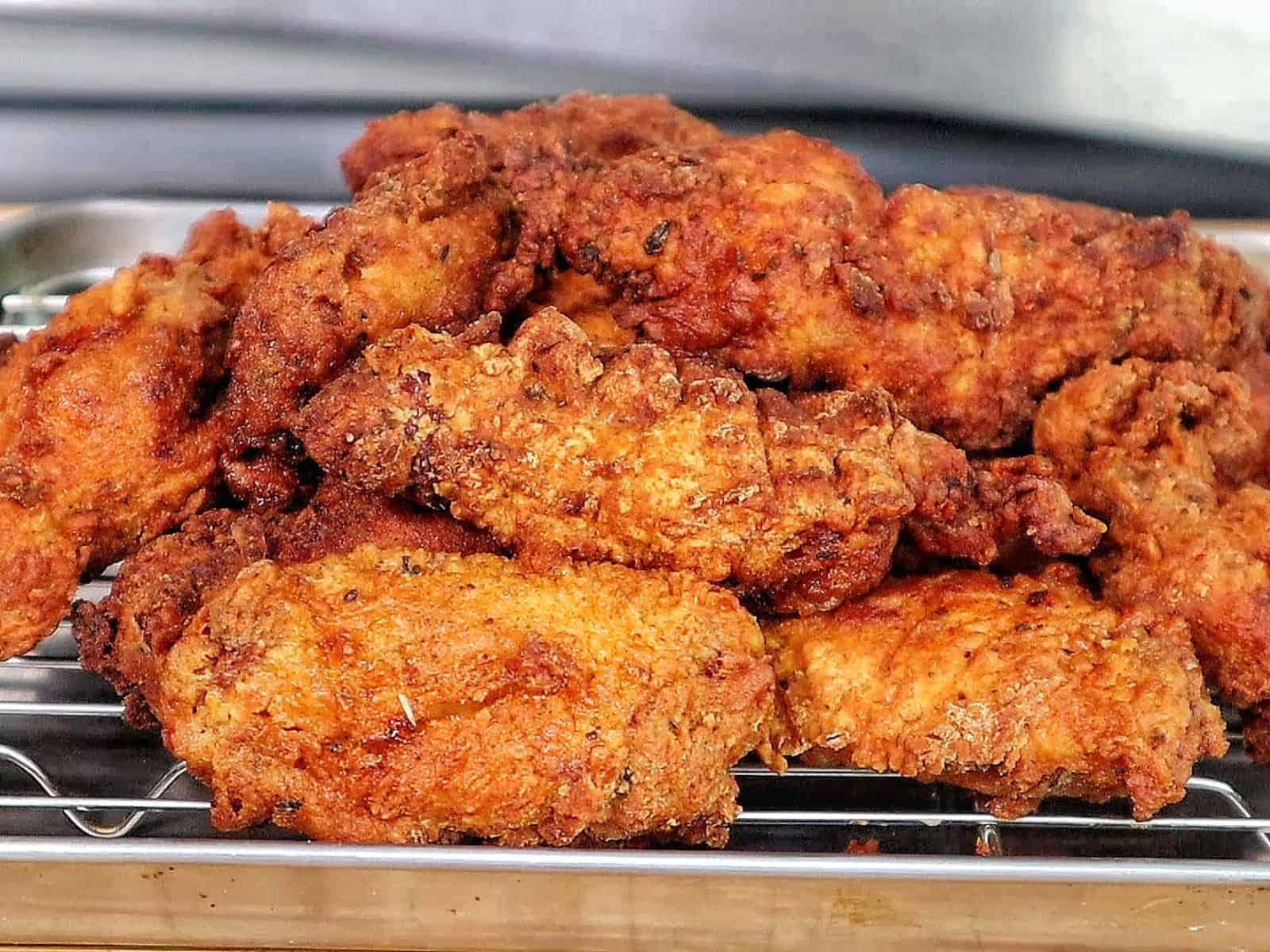 Crispy golden fried chicken wings coated in seasoned flour, with a crunchy textured crust.