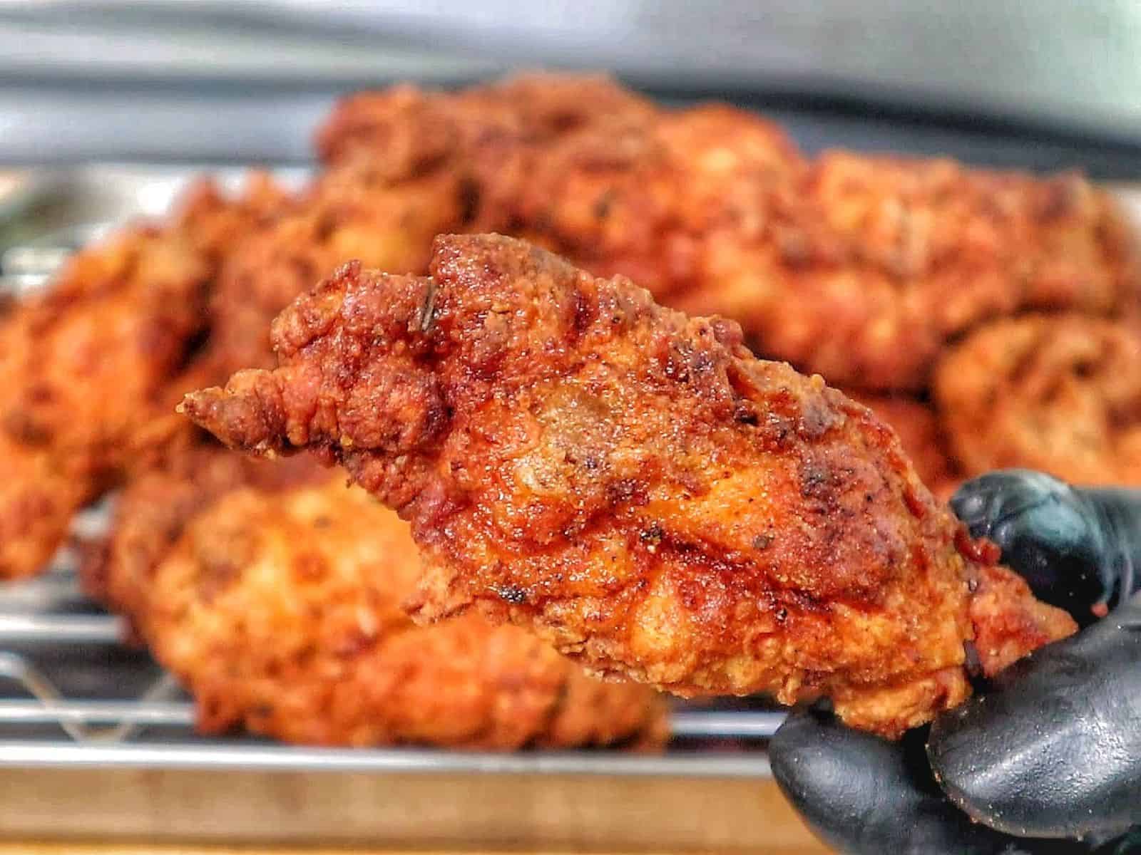 Crispy golden fried chicken wings coated in seasoned flour, with a crunchy textured crust.