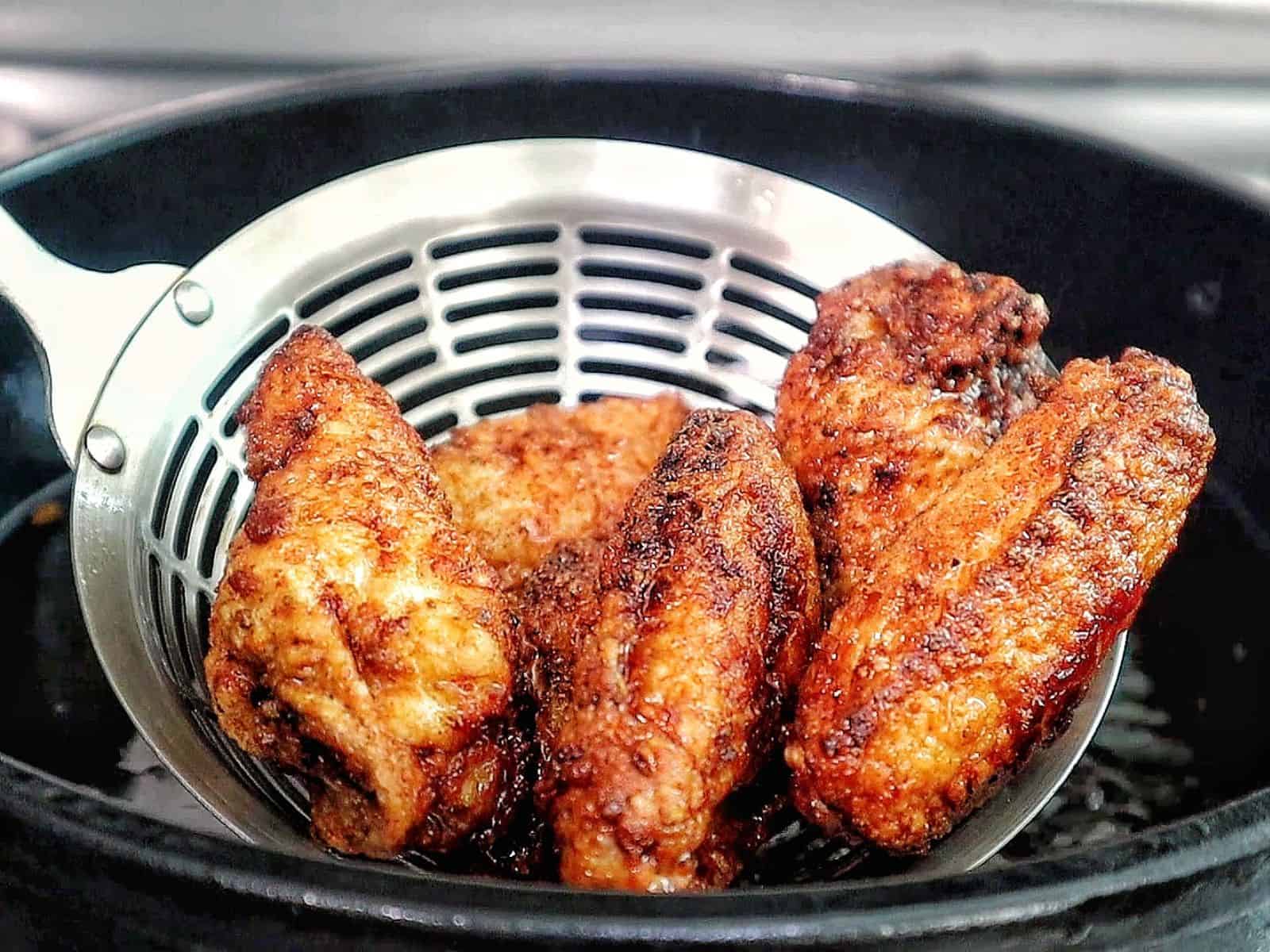 crispy Brazilian-style chicken wings fried until deep golden brown, topped with sautéed garlic, fresh parsley, and a drizzle of garlic-infused olive oil.