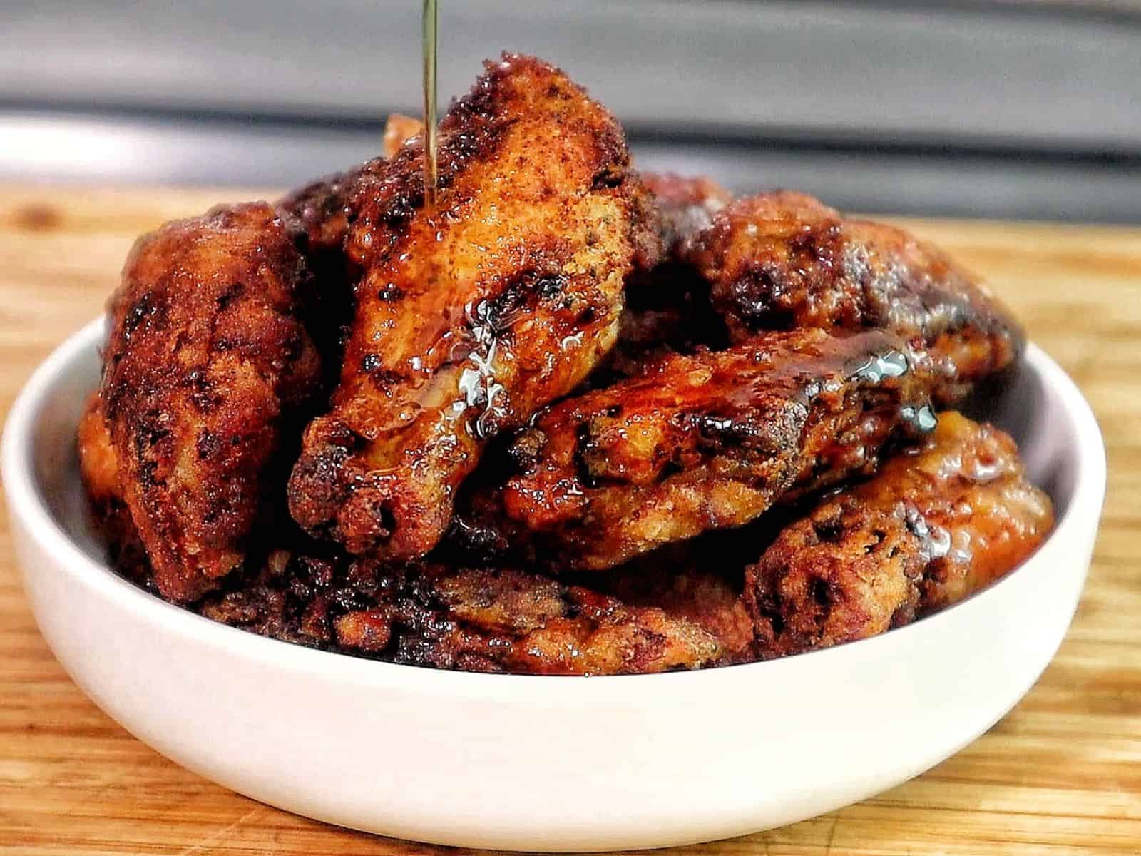 crispy Brazilian-style chicken wings fried until deep golden brown, topped with sautéed garlic, fresh parsley, and a drizzle of garlic-infused olive oil.