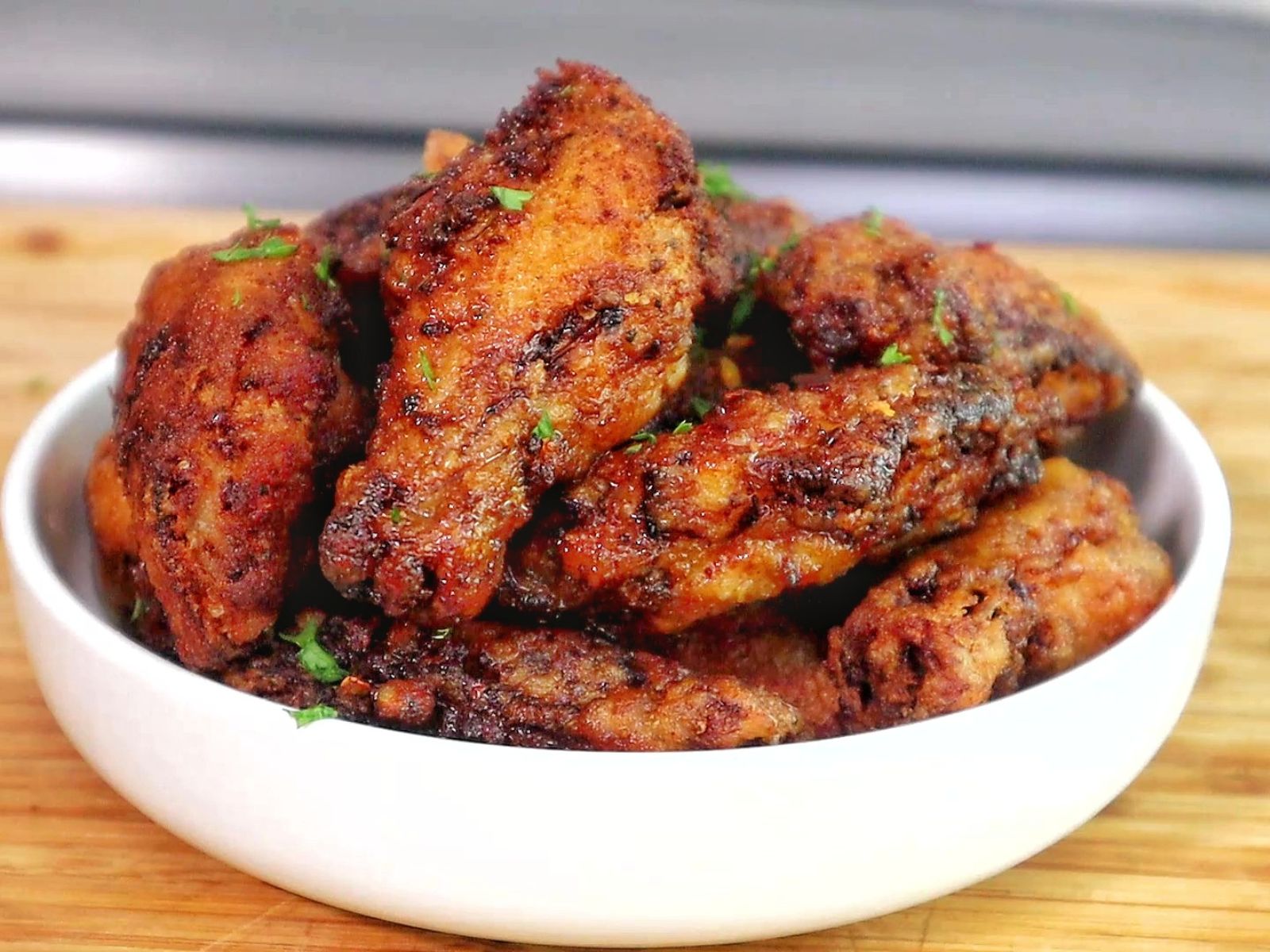 crispy Brazilian-style chicken wings fried until deep golden brown, topped with sautéed garlic, fresh parsley, and a drizzle of garlic-infused olive oil.