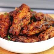 crispy Brazilian-style chicken wings fried until deep golden brown, topped with sautéed garlic, fresh parsley, and a drizzle of garlic-infused olive oil.
