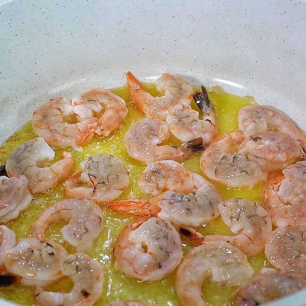 Creamy jambalaya pasta loaded with Cajun-seasoned shrimp, tender chicken thighs, smoked sausage, fettuccine noodles, peppers, celery, onions, and Parmesan cream sauce, garnished with fresh parsley.