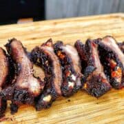 air fryer baby back ribs coated in a dark caramelized BBQ glaze