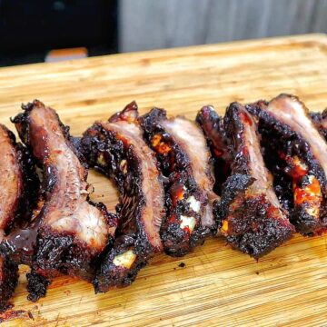 air fryer baby back ribs coated in a dark caramelized BBQ glaze