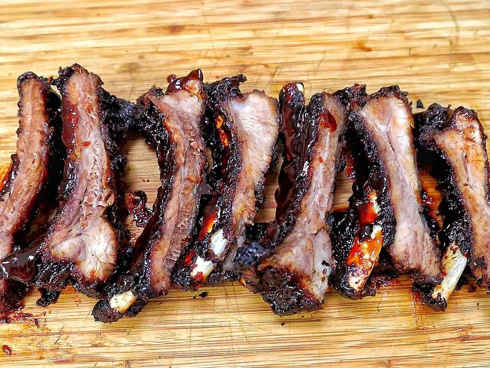 air fryer baby back ribs coated in a dark caramelized BBQ glaze