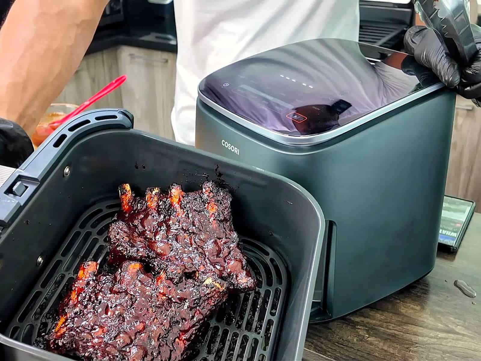 air fryer baby back ribs coated in a dark caramelized BBQ glaze
