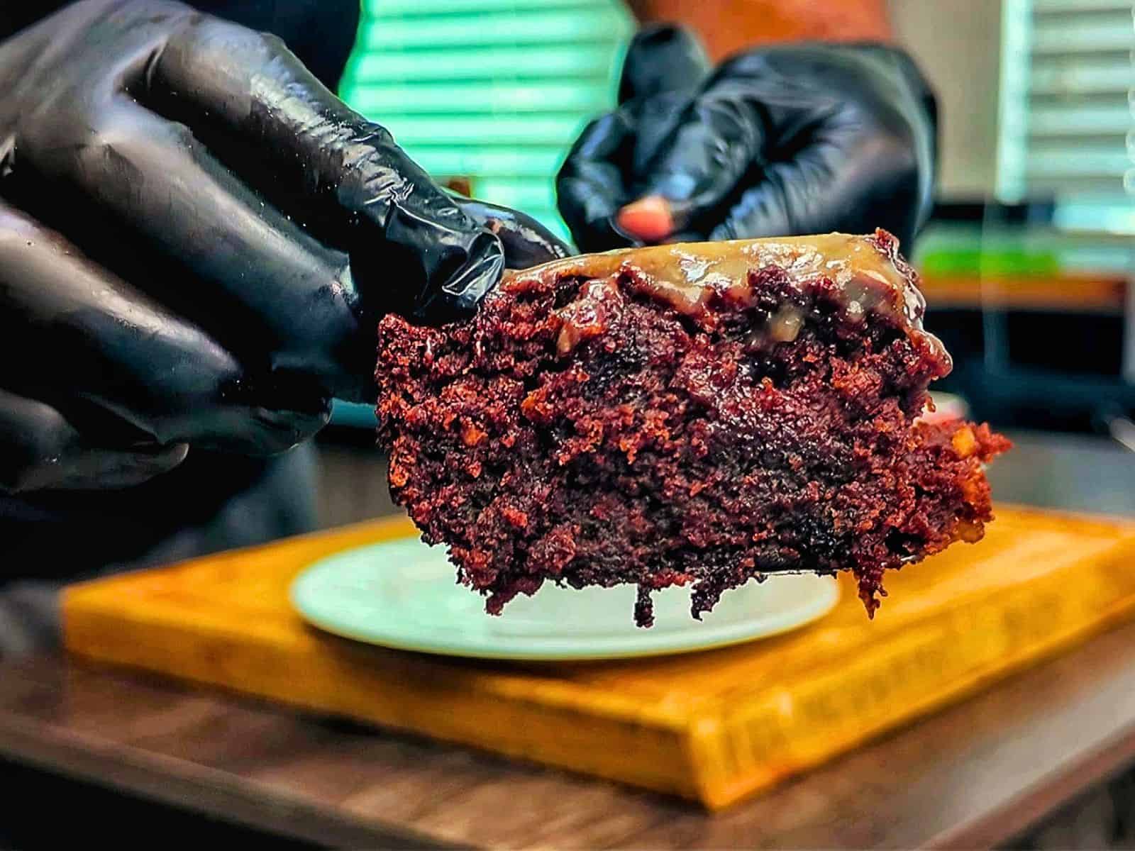A rich chocolate banana bread brownie topped with a brown butter glaze, sliced into thick squares with a moist and fudgy center.