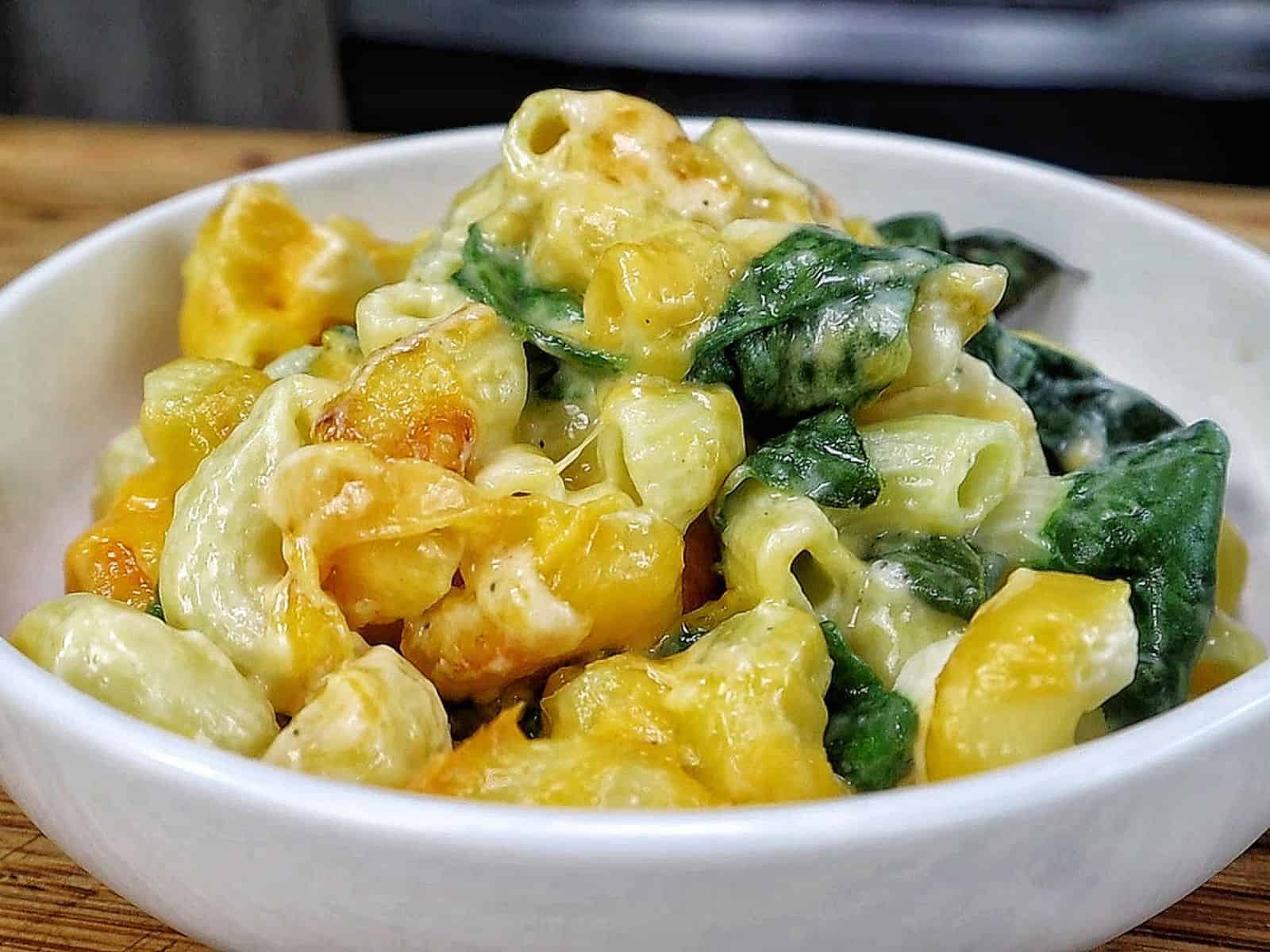 creamy homemade macaroni and cheese made with elbow pasta, fresh spinach, and a rich blend of cheddar, mozzarella, Parmesan, and cream cheese.