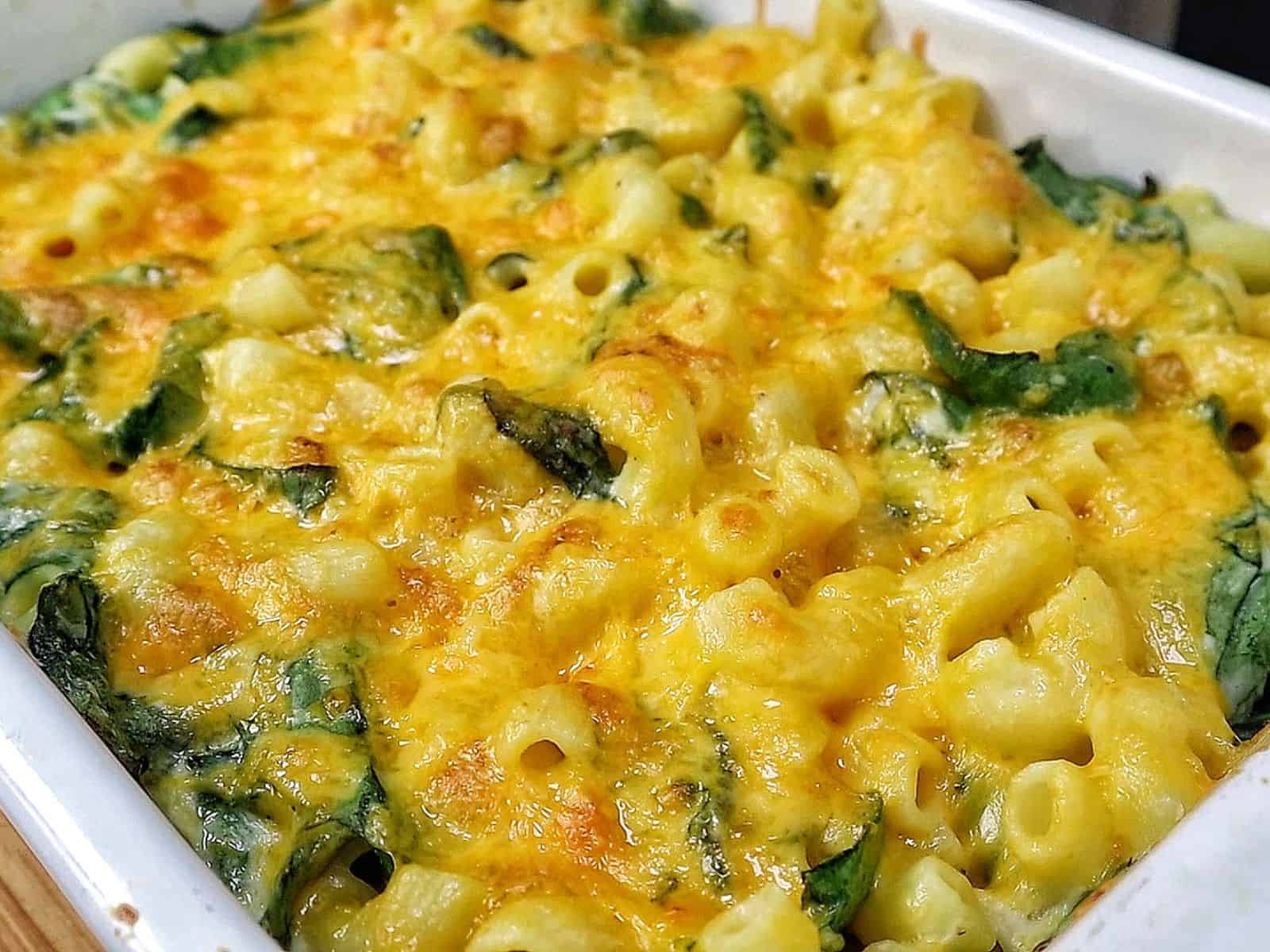 creamy homemade macaroni and cheese made with elbow pasta, fresh spinach, and a rich blend of cheddar, mozzarella, Parmesan, and cream cheese.
