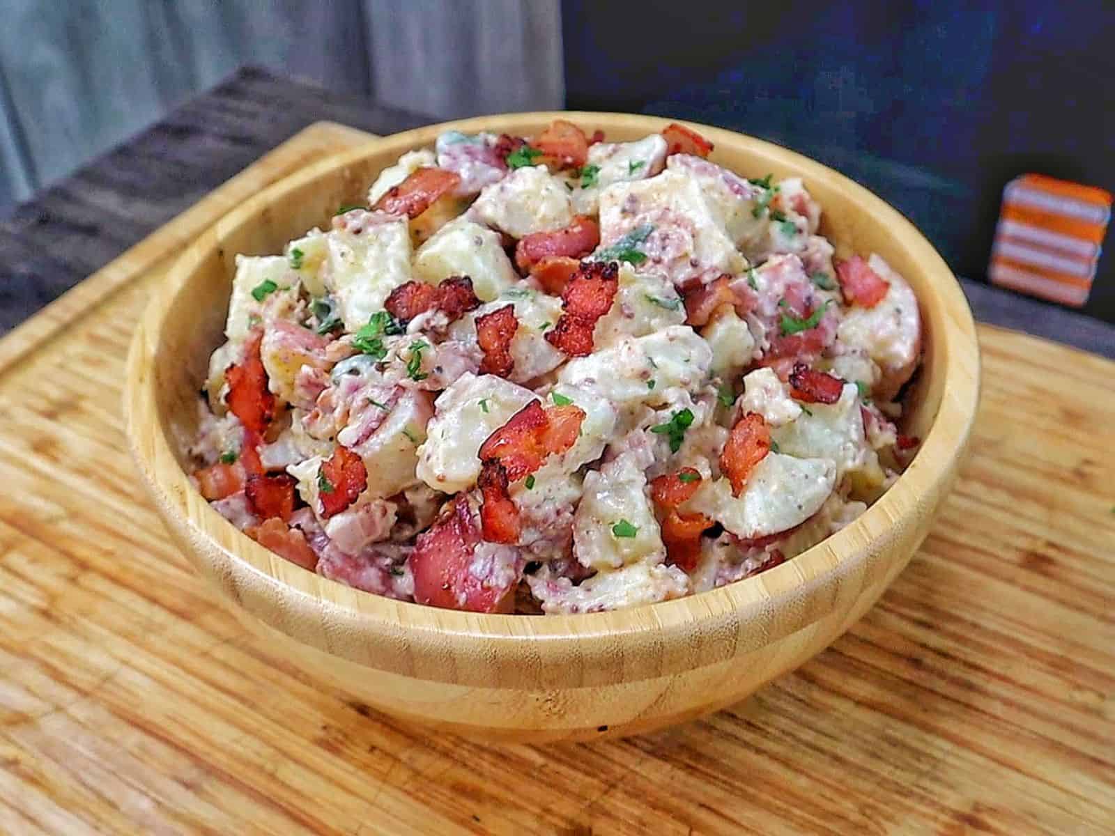 A creamy potato salad made with tender baby potatoes, crispy bacon, red onions, green onions, parsley, and a Dijon mayonnaise dressing.