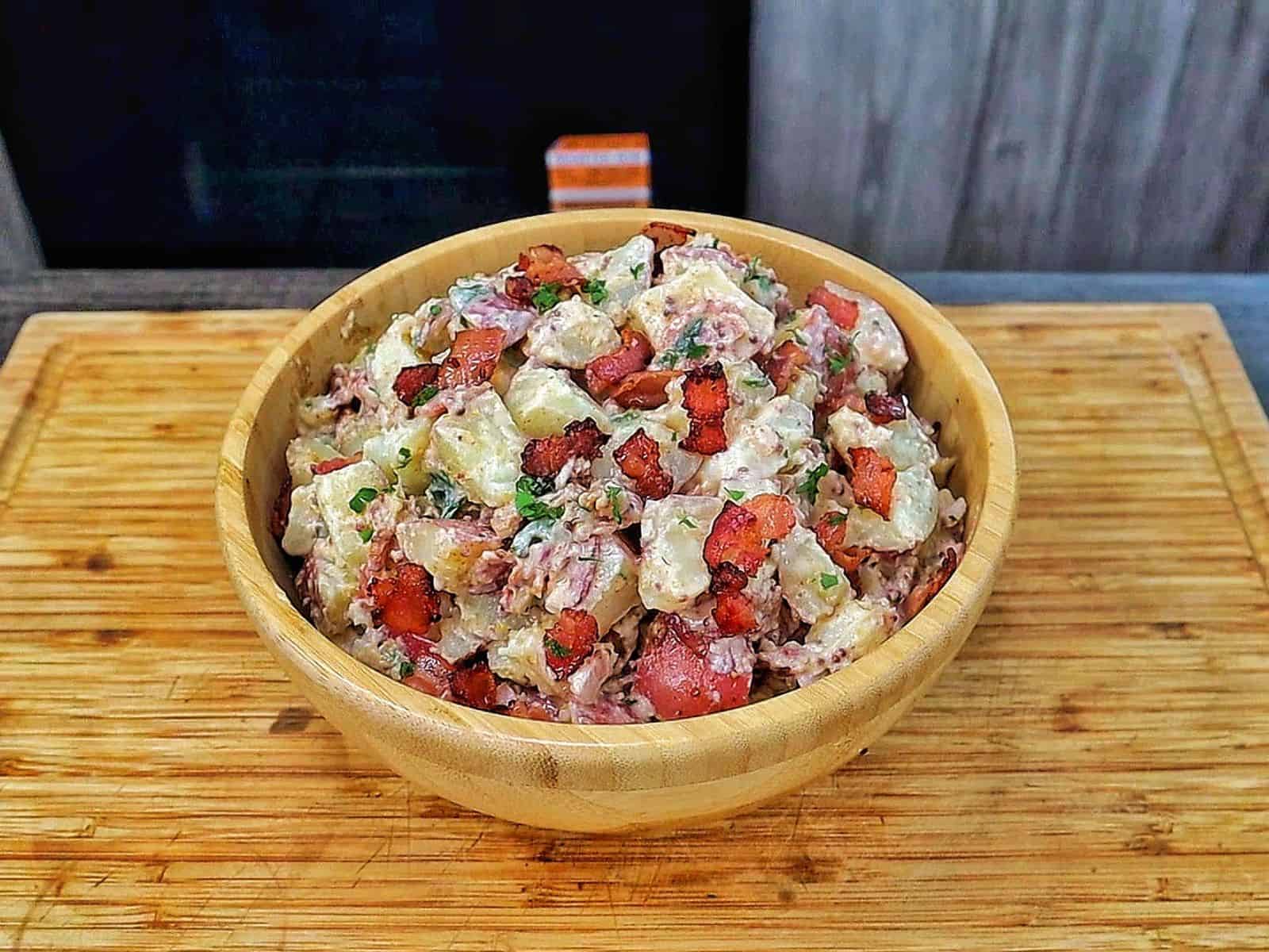 A creamy potato salad made with tender baby potatoes, crispy bacon, red onions, green onions, parsley, and a Dijon mayonnaise dressing.