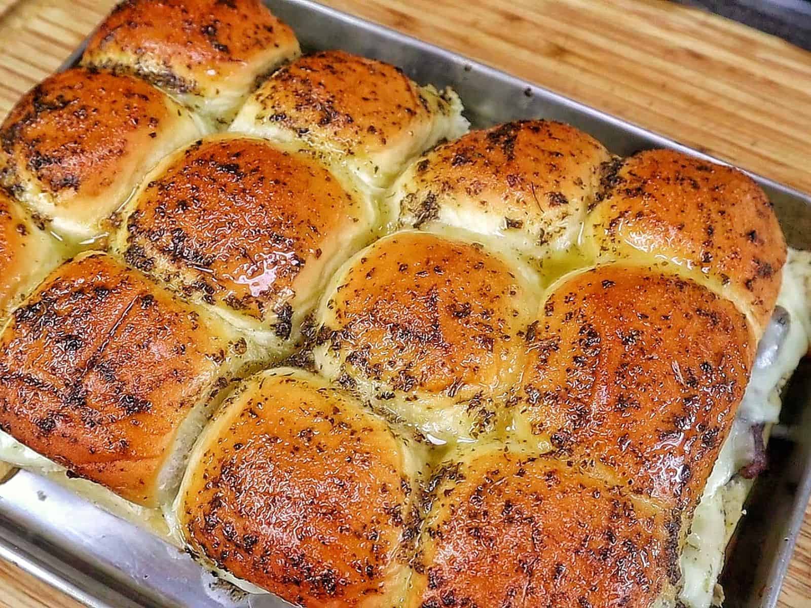 Baked steak and cheese sliders made with tender sirloin steak, caramelized onions, melted provolone cheese, and buttery slider buns.