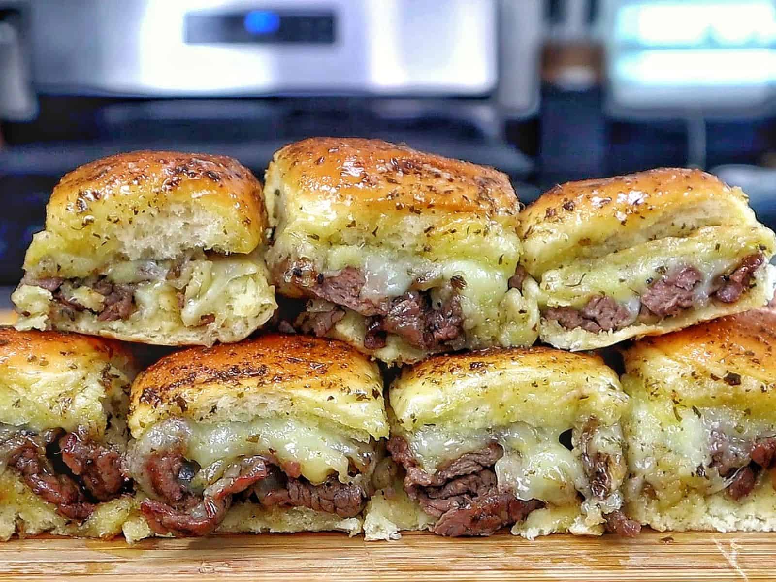 Baked steak and cheese sliders made with tender sirloin steak, caramelized onions, melted provolone cheese, and buttery slider buns.
