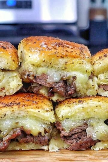 Baked steak and cheese sliders made with tender sirloin steak, caramelized onions, melted provolone cheese, and buttery slider buns.