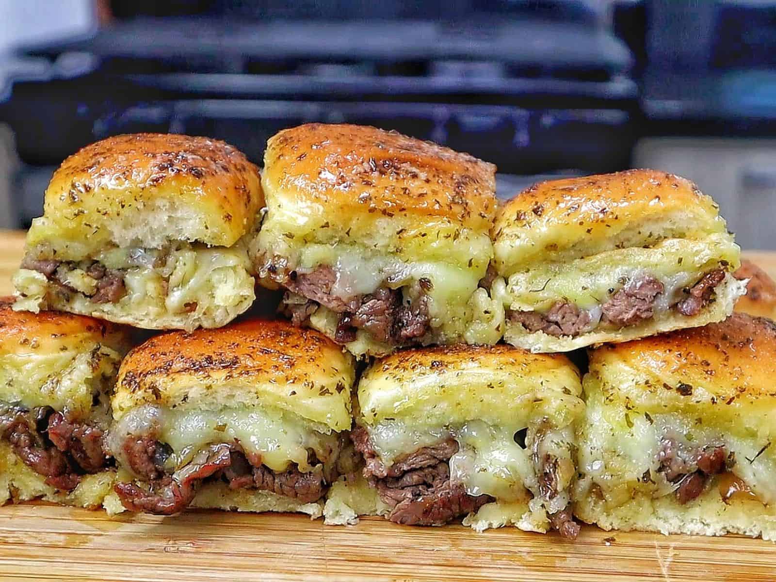Baked steak and cheese sliders made with tender sirloin steak, caramelized onions, melted provolone cheese, and buttery slider buns.