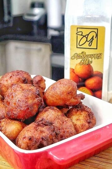 Golden-brown Cajun hush puppies made with seasoned hushpuppy batter, cheddar cheese, onion, and jalapeño, fried until crispy outside and soft and fluffy inside.