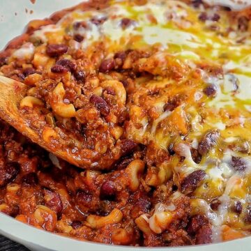 cheesy homemade chili mac made with elbow macaroni, seasoned ground beef, kidney beans, rich tomato sauce, and melted cheddar, Monterey Jack, and mozzarella cheese.