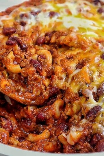 cheesy homemade chili mac made with elbow macaroni, seasoned ground beef, kidney beans, rich tomato sauce, and melted cheddar, Monterey Jack, and mozzarella cheese.