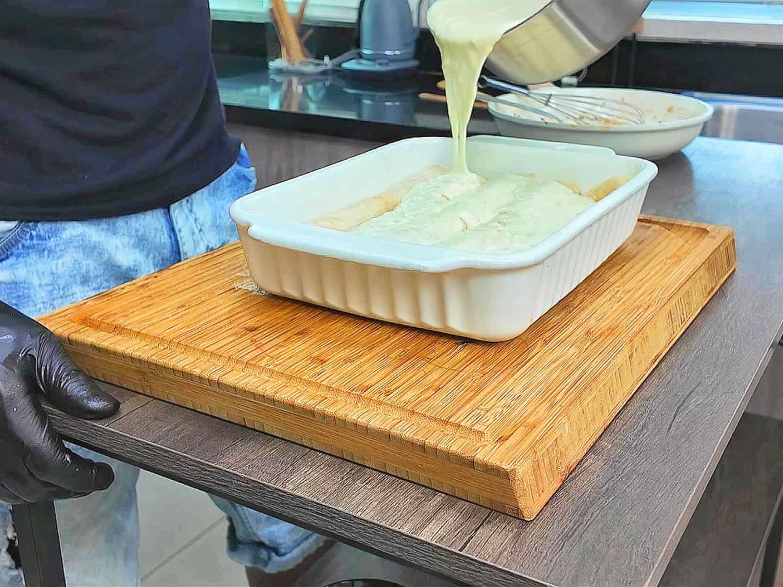 Creamy shrimp enchiladas baked, topped with melted Monterey Jack cheese, sliced jalapeños, and fresh cilantro covered in a rich salsa verde cream sauce.