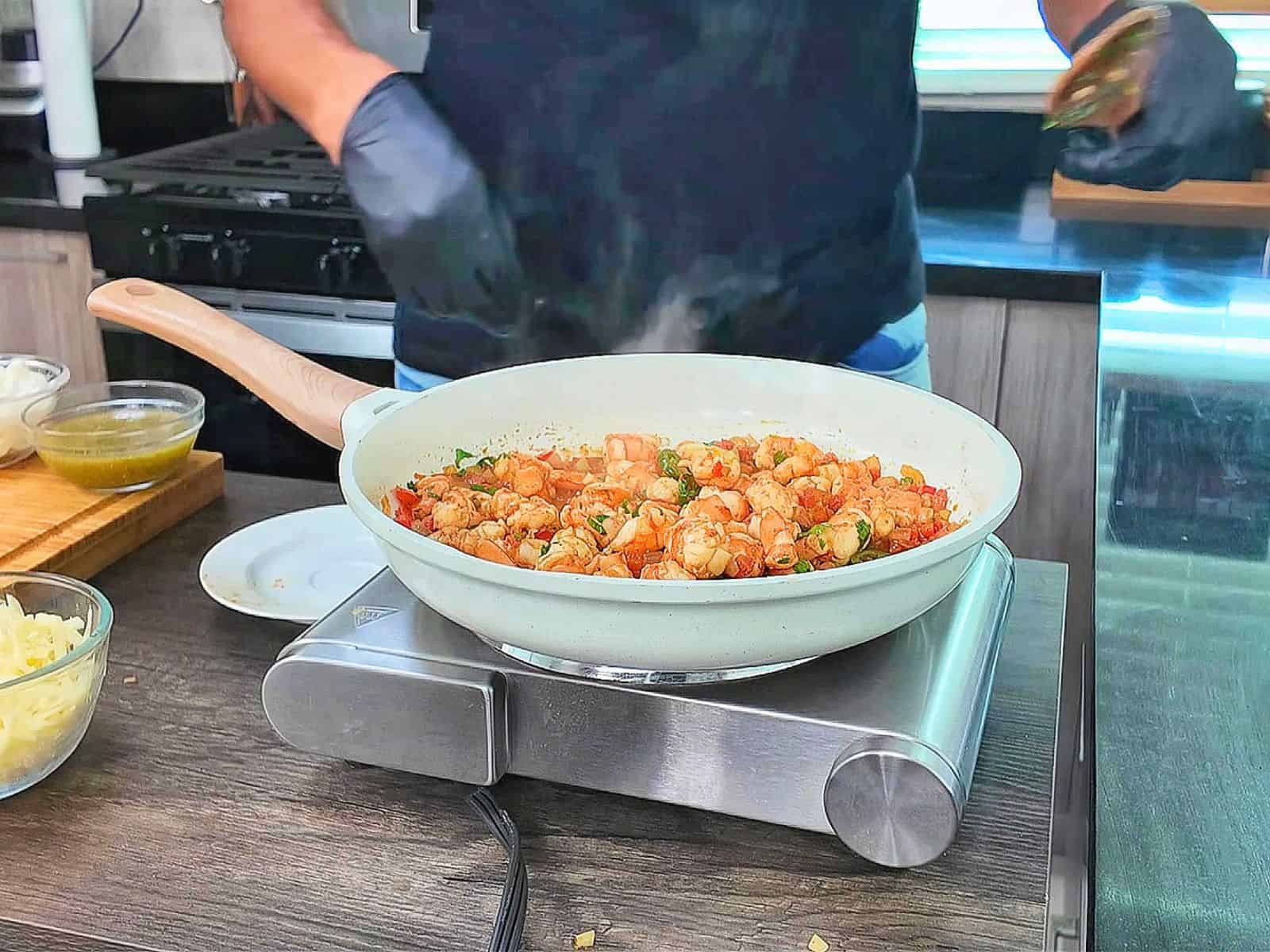 Creamy shrimp enchiladas baked, topped with melted Monterey Jack cheese, sliced jalapeños, and fresh cilantro covered in a rich salsa verde cream sauce.