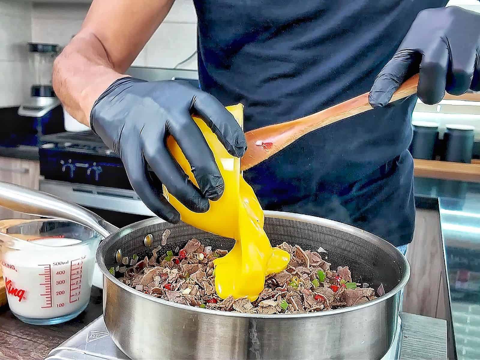Philly Cheesesteak Cheddar Bay Cobbler topped with golden Cheddar Bay biscuit crust, filled with chopped roast beef, onions, bell peppers, and creamy cheddar cheese sauce.