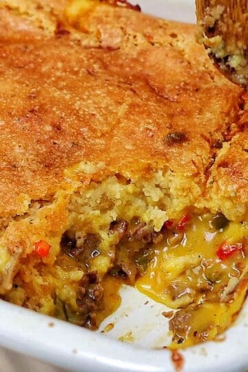 Philly Cheesesteak Cheddar Bay Cobbler topped with golden Cheddar Bay biscuit crust, filled with chopped roast beef, onions, bell peppers, and creamy cheddar cheese sauce.