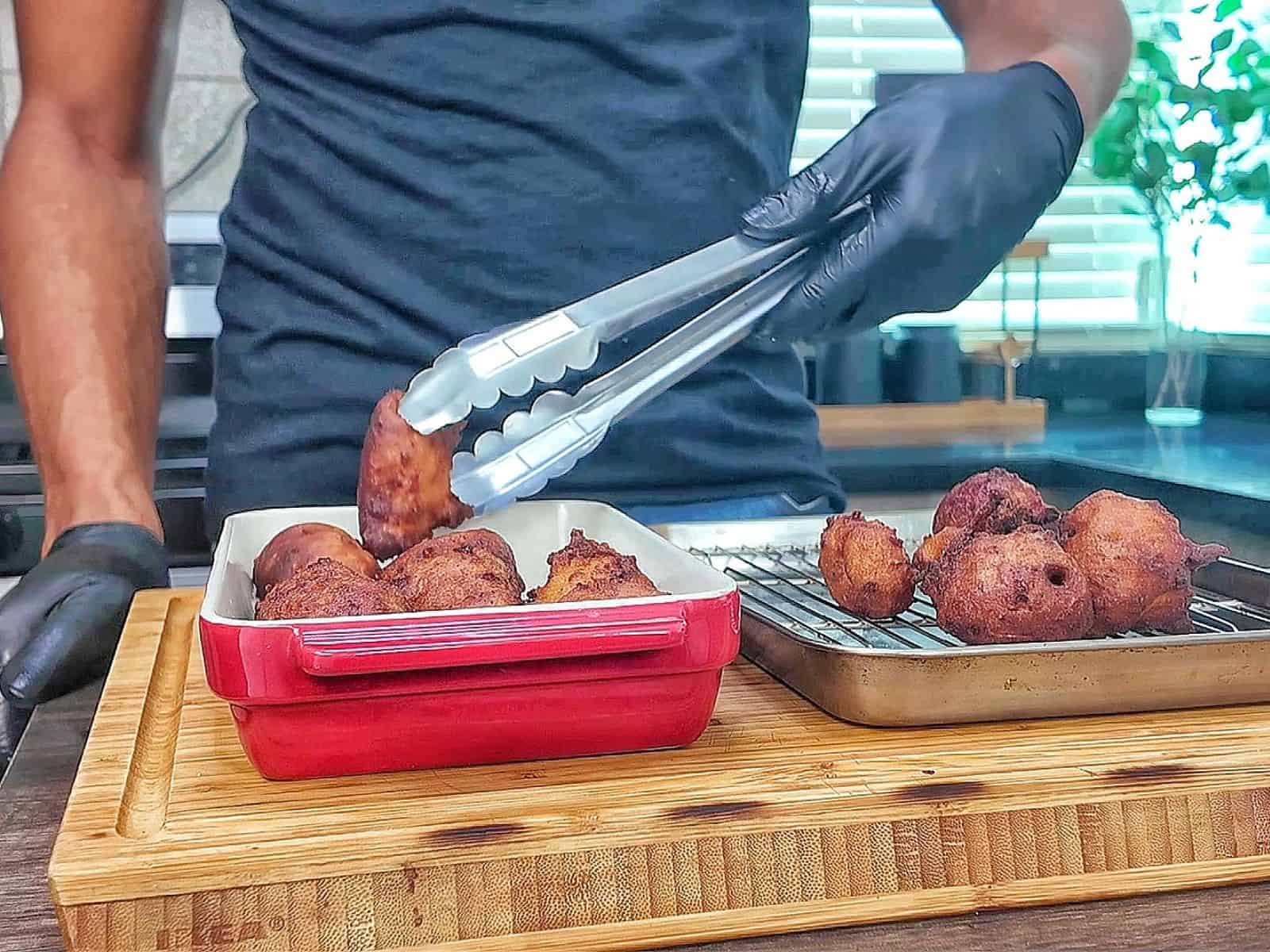 Golden-brown Cajun hush puppies made with seasoned hushpuppy batter, cheddar cheese, onion, and jalapeño, fried until crispy outside and soft and fluffy inside.