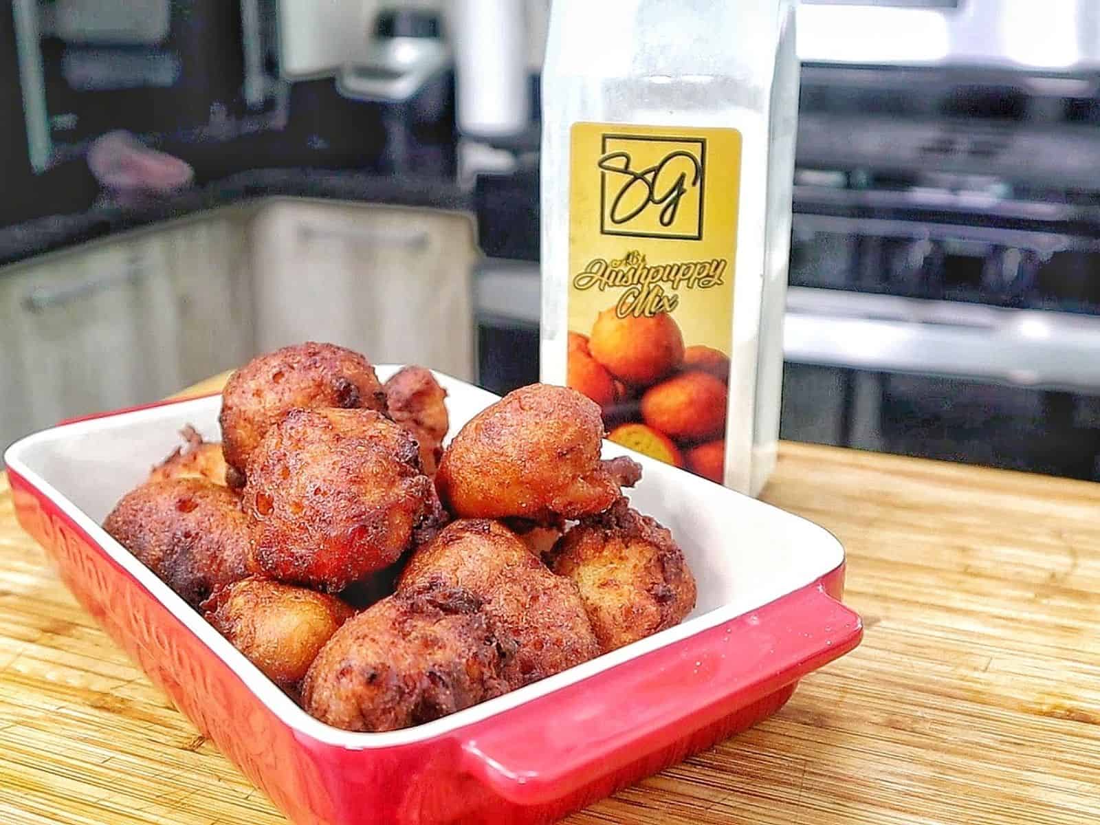 Golden-brown Cajun hush puppies made with seasoned hushpuppy batter, cheddar cheese, onion, and jalapeño, fried until crispy outside and soft and fluffy inside.