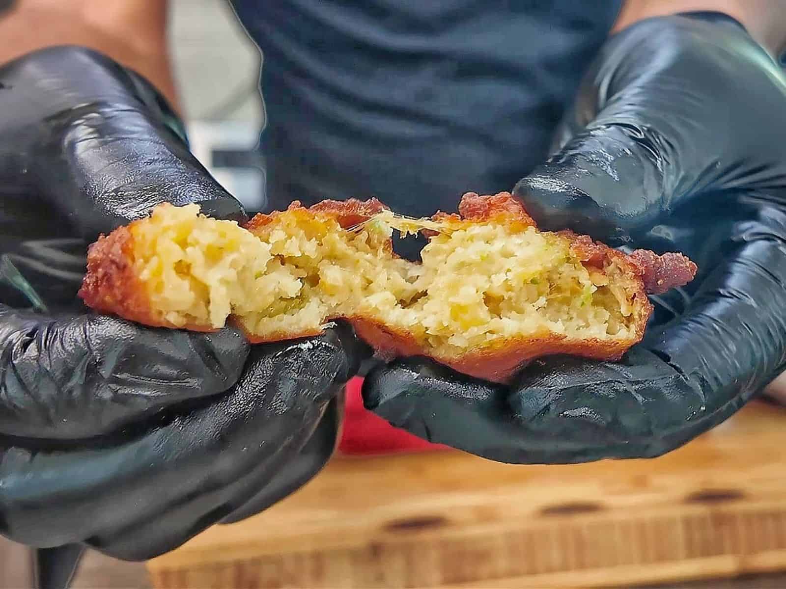 Golden-brown Cajun hush puppies made with seasoned hushpuppy batter, cheddar cheese, onion, and jalapeño, fried until crispy outside and soft and fluffy inside.