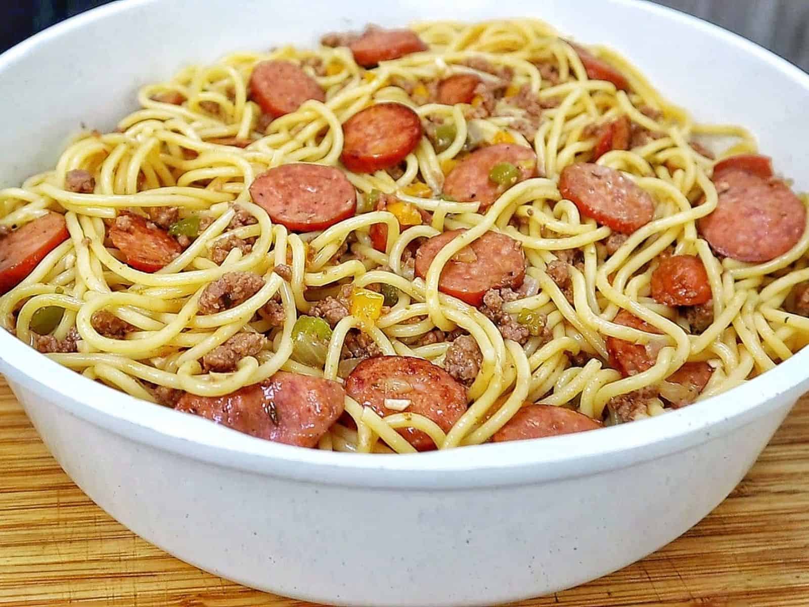 Close-up of Dirty Spaghetti made with tender spaghetti noodles, seasoned ground beef, sliced smoked sausage, onions and colorful bell peppers tossed in a rich, savory beef sauce.