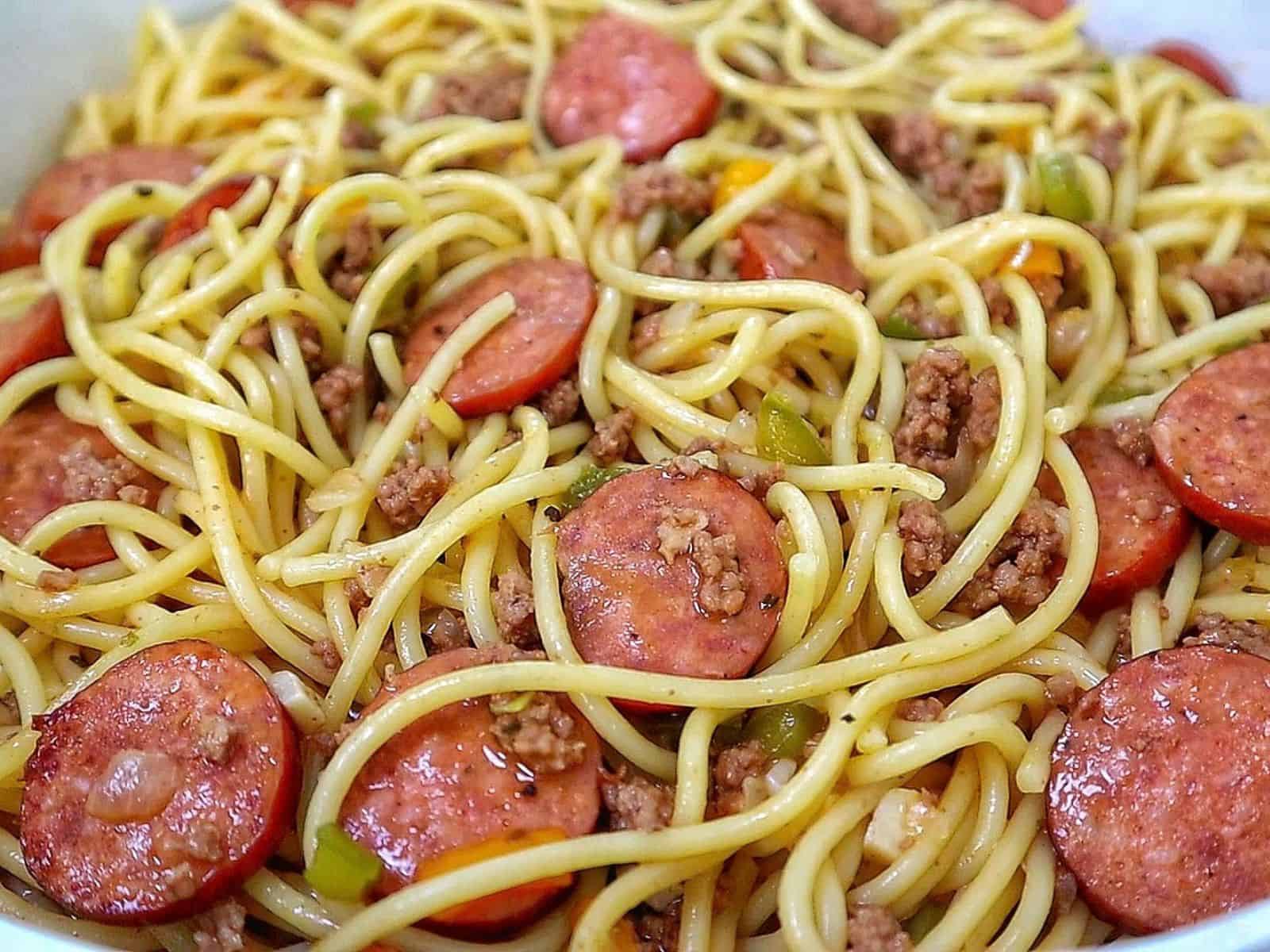 Close-up of Dirty Spaghetti made with tender spaghetti noodles, seasoned ground beef, sliced smoked sausage, onions and colorful bell peppers tossed in a rich, savory beef sauce.