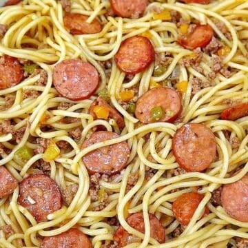 Close-up of Dirty Spaghetti made with tender spaghetti noodles, seasoned ground beef, sliced smoked sausage, onions and colorful bell peppers tossed in a rich, savory beef sauce.