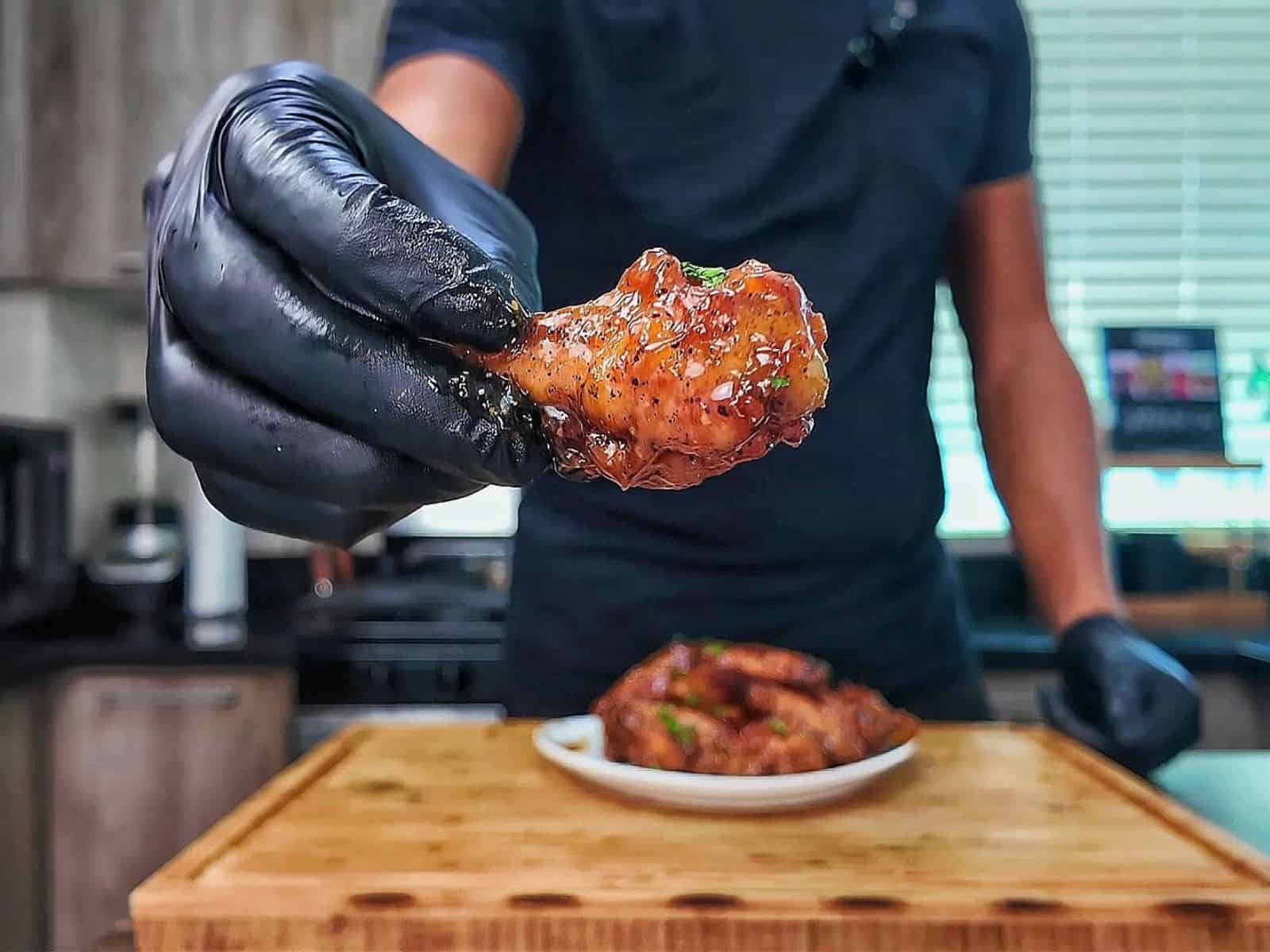Crispy baked lemon pepper chicken wings coated in a sticky honey lemon glaze and garnished with fresh chopped parsley.