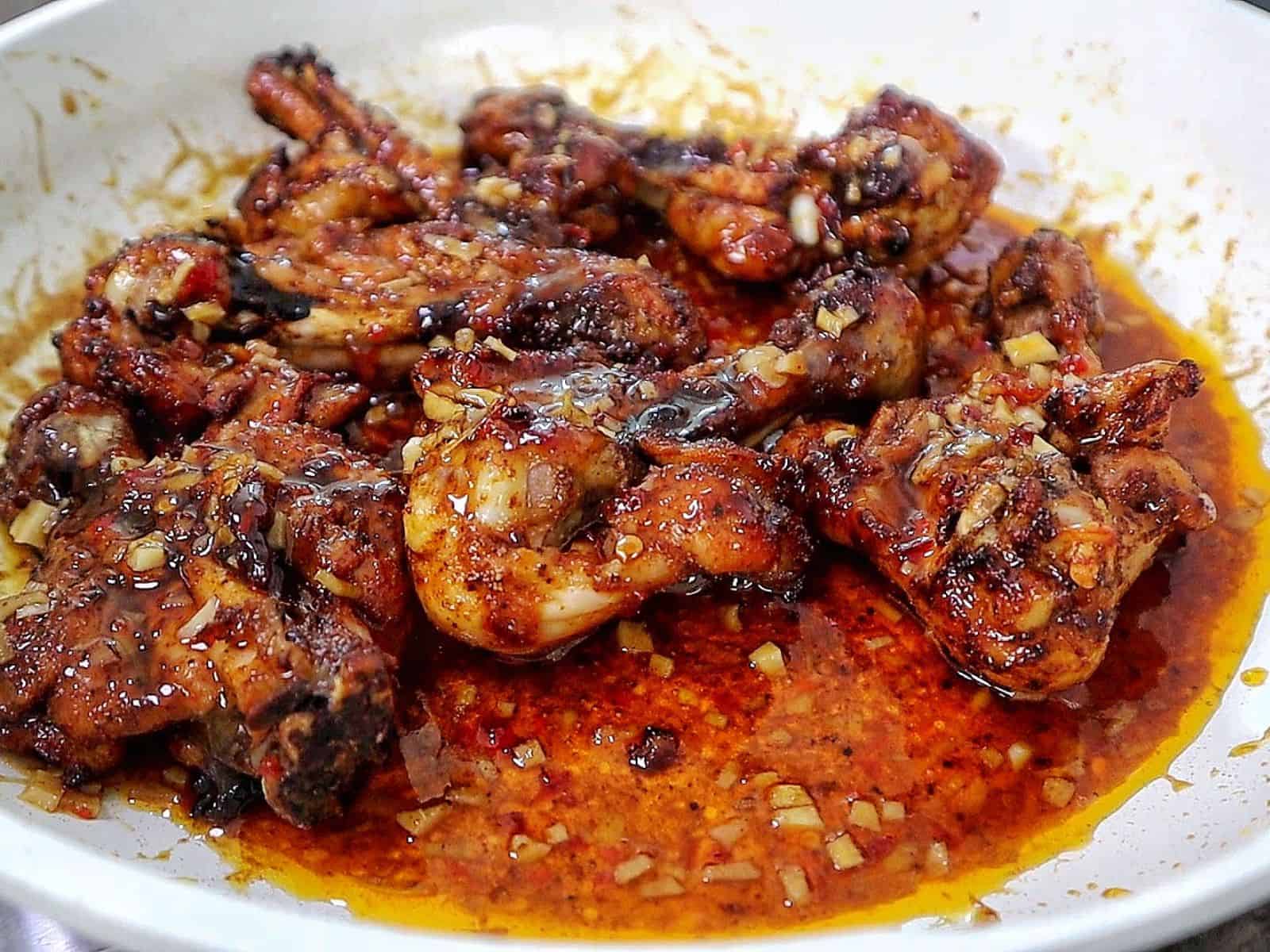 Butterflied chicken drumsticks coated in a glossy sweet chili garlic sauce with minced garlic, soy sauce, chili oil, and crispy caramelized edges.