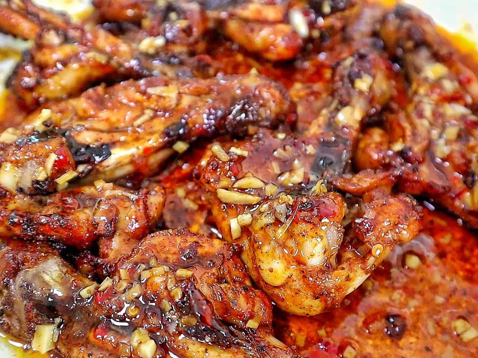 Butterflied chicken drumsticks coated in a glossy sweet chili garlic sauce with minced garlic, soy sauce, chili oil, and crispy caramelized edges.