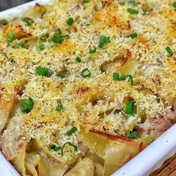 Homemade tuna noodle casserole made with wide egg noodles, tuna, peas and a creamy white cheddar sauce, topped with crispy golden Parmesan Panko breadcrumbs and fresh chopped chives.